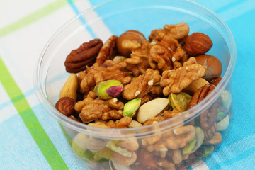 Mixed nuts in plastic box, close up