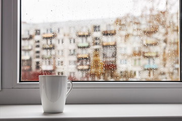 cup of hot coffee on the window