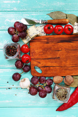 Different types of cheese with empty board on table close-up