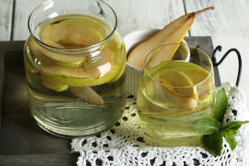 Sangria drink in glass and jar on wooden background