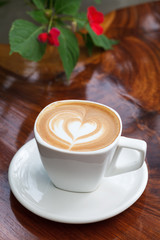 Cup of latte coffee on wooden