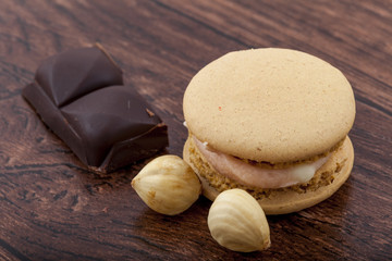 Sweet and colorful French macaroons on wooden background