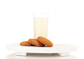 Milk and cookies on wooden tray isolated on white