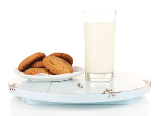 Milk and cookies on wooden tray isolated on white