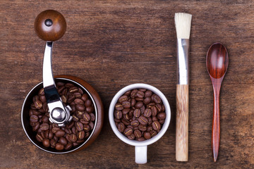 cup of coffee beans on the brown wooden background
