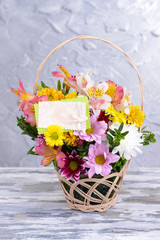 Fototapeta na wymiar Beautiful bouquet of bright flowers in wicker basket