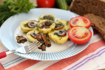 Young boiled potatoes on table, close up