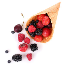 Different ripe berries in sugar cone, isolated on white