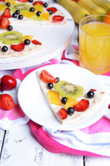 Sweet pizza with fruits on table close-up