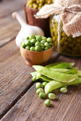 Fresh  and canned peas in bowl and glass jar