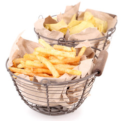 Tasty french fries in metal basket and potato chips, isolated