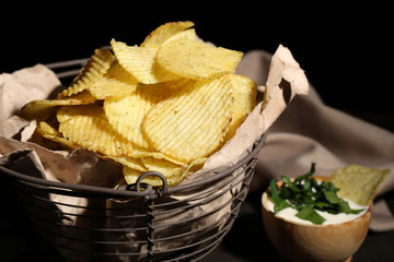 Tasty potato chips in metal basket