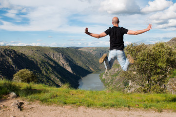 Fototapeta premium Young man jumping. Arribes del Duero river natural park