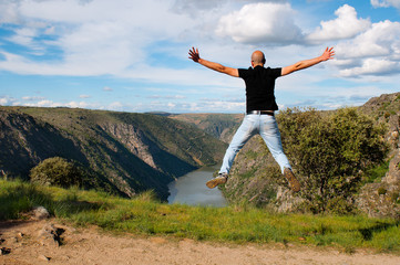 Young man jumping. Arribes del Duero river natural park