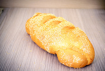 Fresh Tasty Bread on Woody Background.