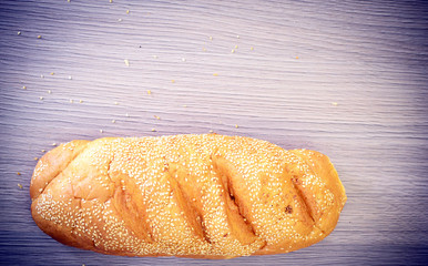 Fresh Tasty Bread on Woody Background.