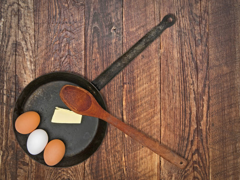 vintage set for frying eggs over wooden table