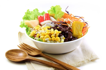 Salad and wood spoon, fork on cloth