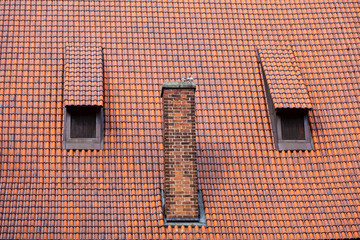 Architecture detail chimney and garret red tiles roof