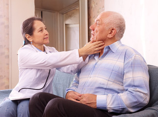 Fototapeta premium mature doctor examining senior man