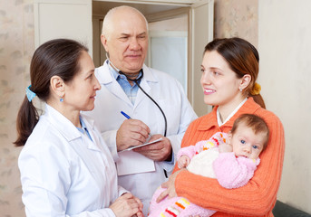  woman with baby and doctors