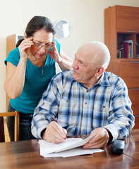  mature couple reading financial documents