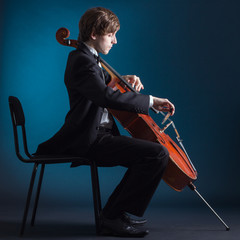 Cellist playing classical music on cello - 67273577
