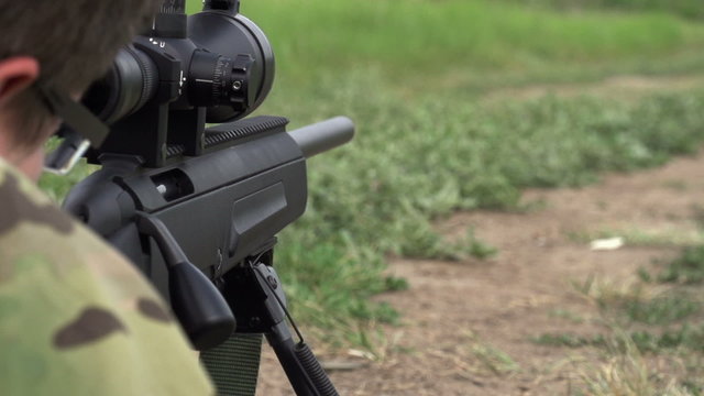 Sniper Shoots from a Rifle