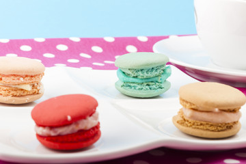 Obraz na płótnie Canvas Sweet and colorful French macaroons on pastel background