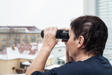 Fototapeta na wymiar Senior woman with binoculars