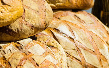 many brown rustic fresh rye bread loaves