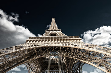 Fototapeta na wymiar Paris. Powerful structure of Magnificent Eiffel Tower at sunset
