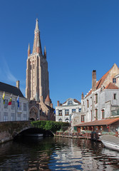 Fototapeta na wymiar Bruges - Church of Our Lady and canal in morning light