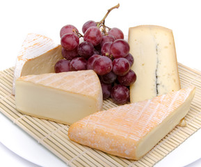 Composition of different cheeses on a straw placemat