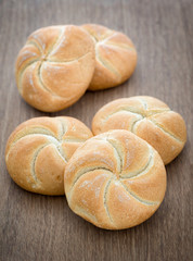 Homemade fresh bread buns  on old wooden table, selective focus