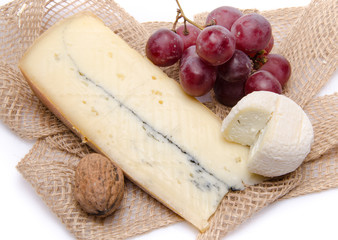 Cheeses and grapes on a burlap