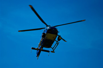 Fototapeta na wymiar Blue sky blue helicopter that flies.