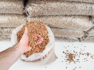 wood pellets in mans hand