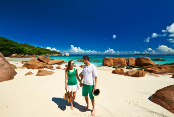 Couple in green on a beach at Seychelles