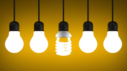 Glowing spiral light bulb hanging among tungsten ones on yellow