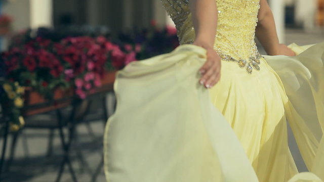 Beautiful young pretty girl in lemony long strapless dress