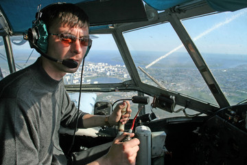 Young pilot in the cockpit aircraft during flight