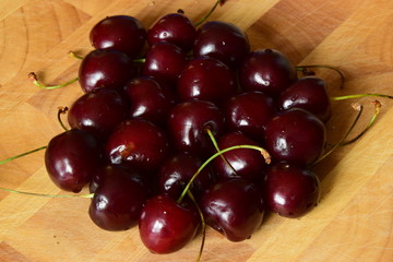 Ripe cherries on a wooden table