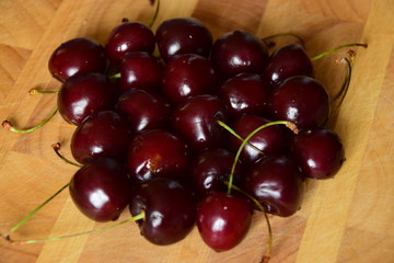 Ripe cherries on a wooden table