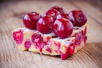 slice of cherry pie on a wooden background