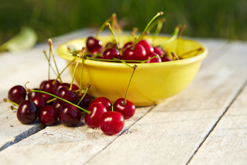 Several cherries on an old wooden table