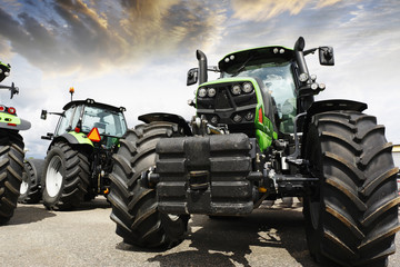 giant tractors set against a sunset sky and clouds