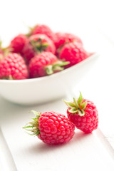 raspberries on white table