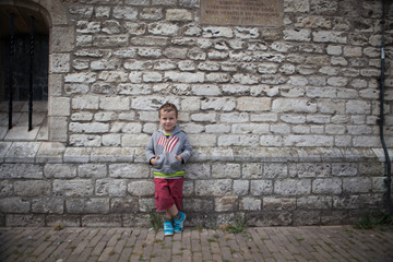 cute boy in front of wall