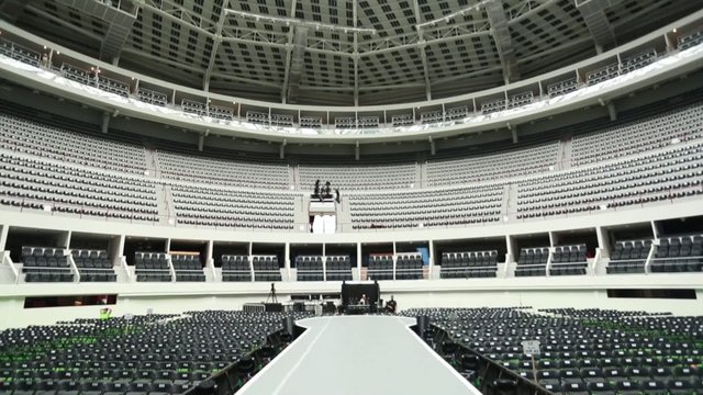 A white runway at empty coliseum before a show.